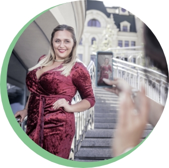 Confident plus size woman geting her photo taken in a pretty red dress